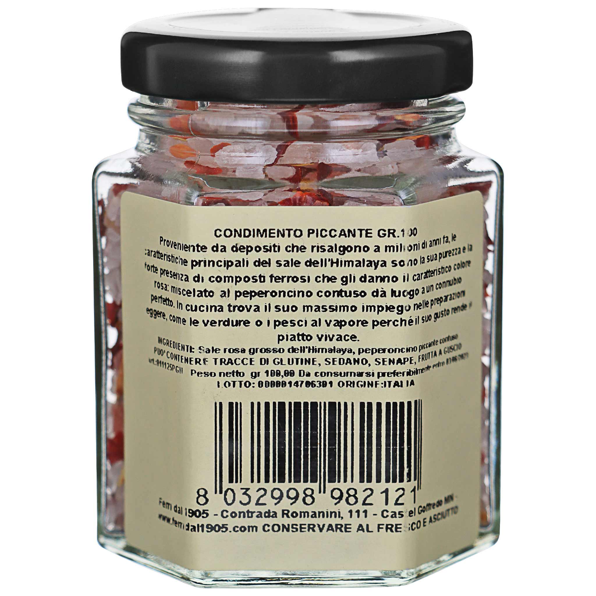 Glasgefäss mit schwarzem Deckel, gefüllt mit rotem, scharfem Gewürz aus Himalaya-Salz und Peperoncino. Etikett mit…
